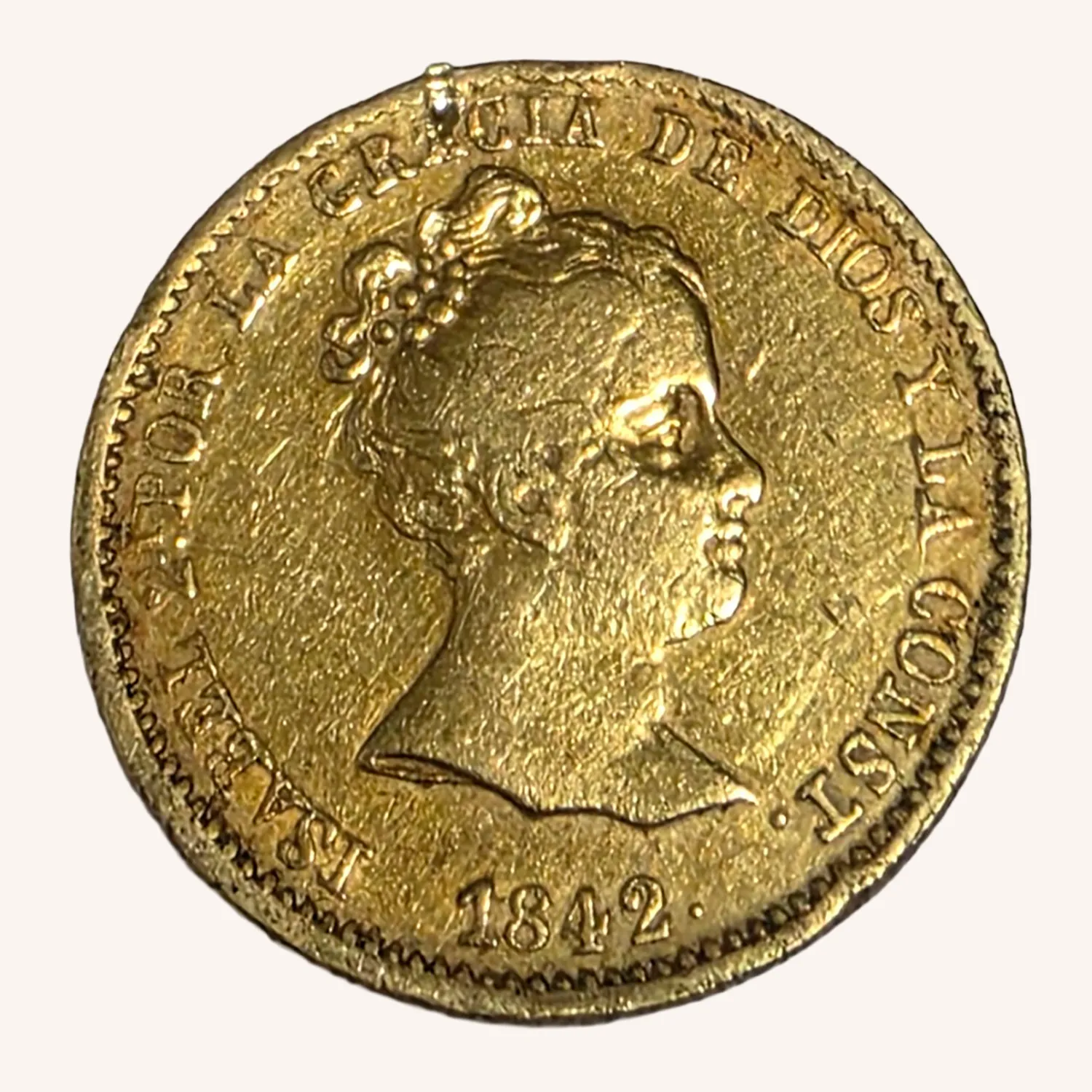 Moneda dorada de 1842 con retrato femenino de perfil