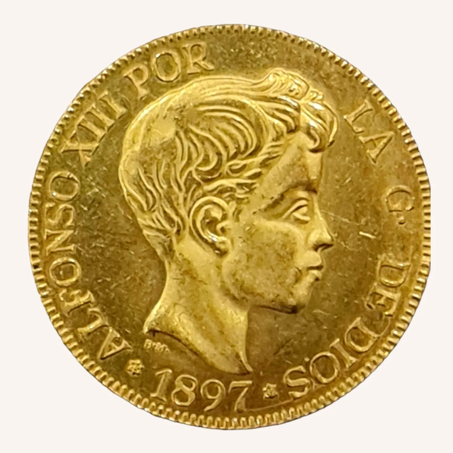 Moneda dorada de 1897 con busto masculino de perfil